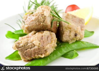 photo of delicious diced meat with rosemary and peas