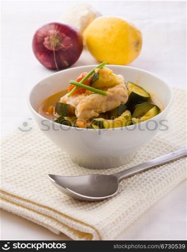 photo of delicious fish soup with cod and zucchini