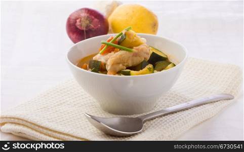 photo of delicious fish soup with cod and zucchini