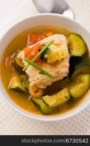 photo of delicious fish soup with cod and zucchini