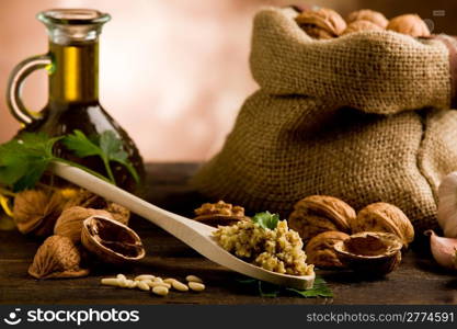 photo of delicious fresh ingredients for walnut pesto on wooden table