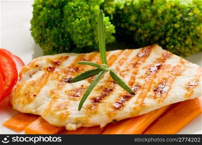 photo of delicious grilled chicken breast with various vegetables