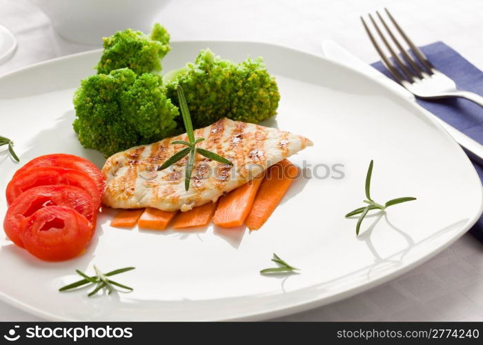 photo of delicious grilled chicken breast with various vegetables