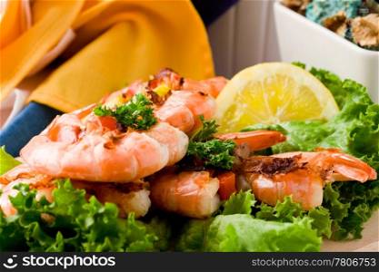 photo of delicious grilled prawns over lettuce bed with peperoni