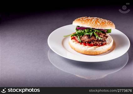 photo of delicious Hamburger with Arugula on grey surface