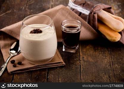 photo of delicious homemade and decomposed tiramisu on wooden table