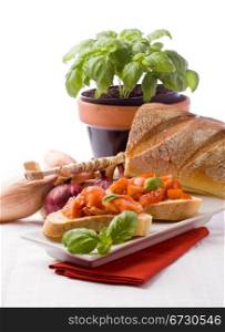 photo of delicious italian bruschetta with basil and ingredients