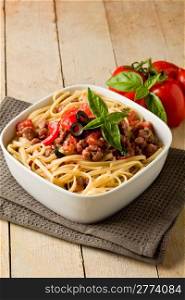 photo of delicious italian pasta with meat sauce on wooden table