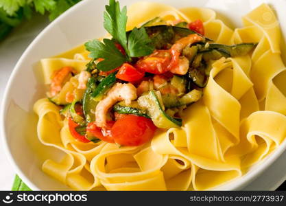 photo of delicious italian pasta with zucchini and shrimps