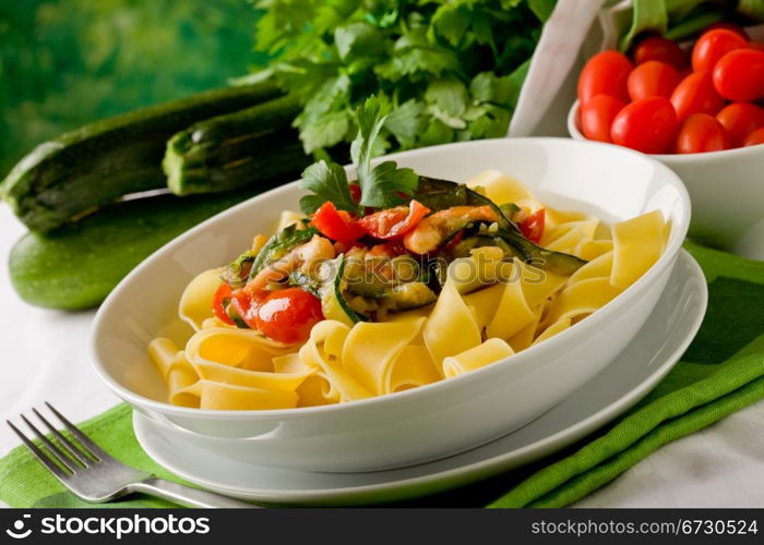 photo of delicious italian pasta with zucchini and shrimps