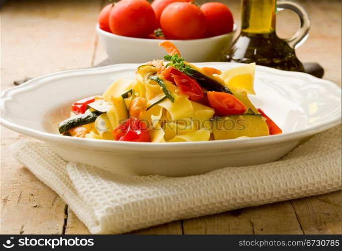 photo of delicious italian pasta with zucchini and shrimps