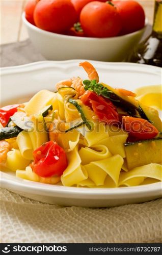 photo of delicious italian pasta with zucchini and shrimps