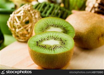 photo of delicious kiwi on cutting board with decorations arround