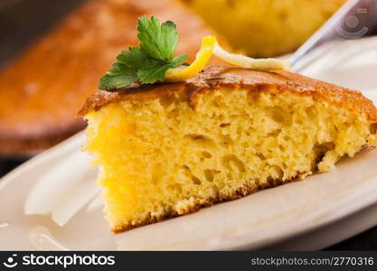 photo of delicious lemon sponge cake on wooden table