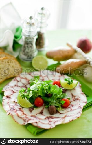 photo of delicious octopus carpaccio with mixed salad illuminated by daylight