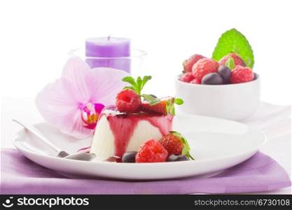 photo of delicious panna cotta dessert with berries