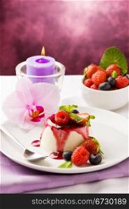 photo of delicious panna cotta dessert with berries