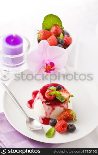 photo of delicious panna cotta dessert with berries