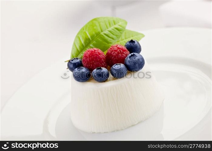 photo of delicious panna cotta with berries on whitetable