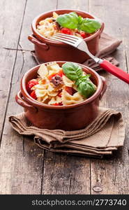 photo of delicious pasta with cherry tomatoes and olives on wooden table