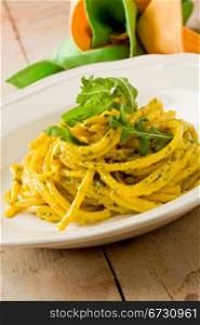 photo of delicious pasta with saffron and arugula pesto