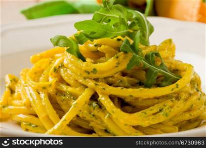 photo of delicious pasta with saffron and arugula pesto