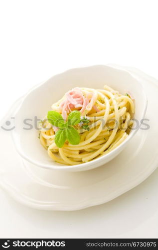 photo of delicious pasta with sour cream and ham on isolated background