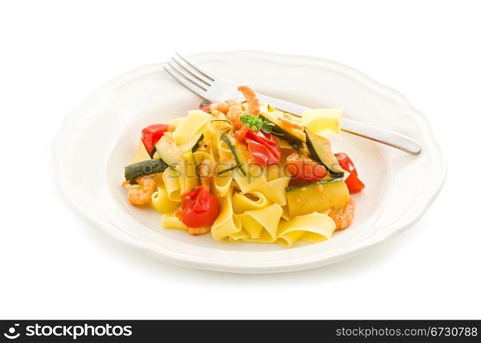 photo of delicious pasta with zucchini and shrimps on white isolated background