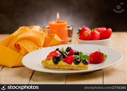 photo of delicious pie with strawberries in front of a rural background