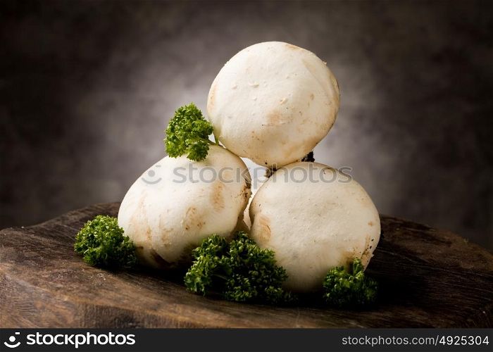 photo of delicious raw mushrooms on wooden table