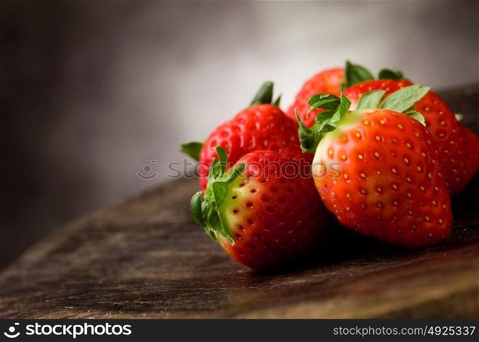 photo of delicious red strawberries on wooden table