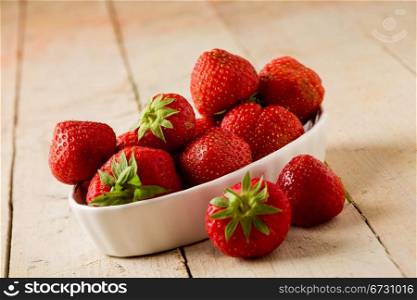 photo of delicious red strawberries on wooden table