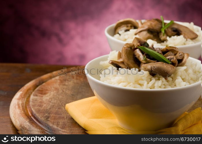 photo of delicious risotto with mushrooms on wooden table