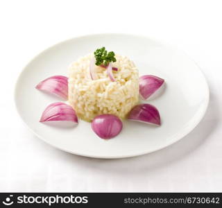 photo of delicious risotto with red onions on white isolated background