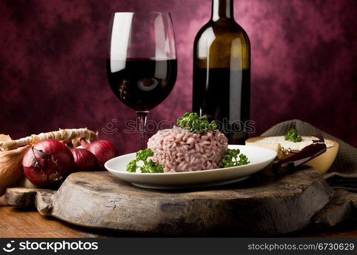photo of delicious risotto with red wine on wooden table