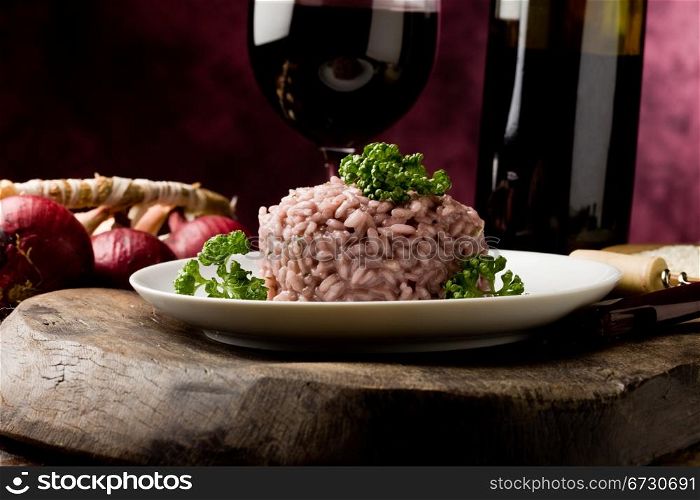 photo of delicious risotto with red wine on wooden table
