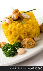 photo of delicious risotto with saffron and seafood on white isolated background