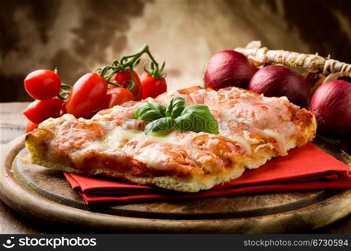photo of delicious slice of pizza with basil leaf on it