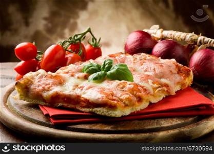 photo of delicious slice of pizza with basil leaf on it