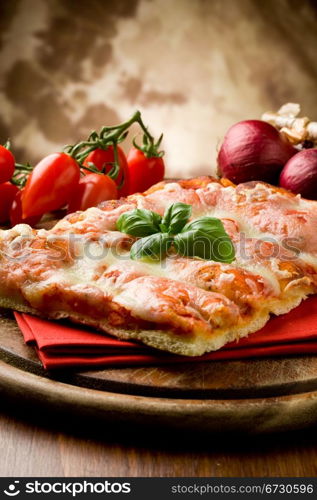 photo of delicious slice of pizza with basil leaf on it