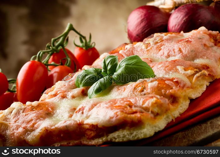 photo of delicious slice of pizza with basil leaf on it