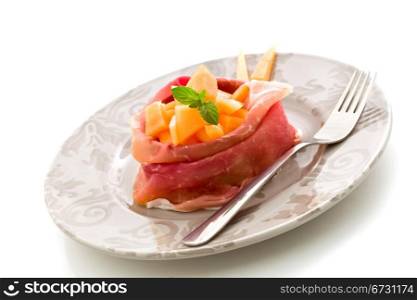 photo of delicious sliced bacon with melon inside on white isolated background