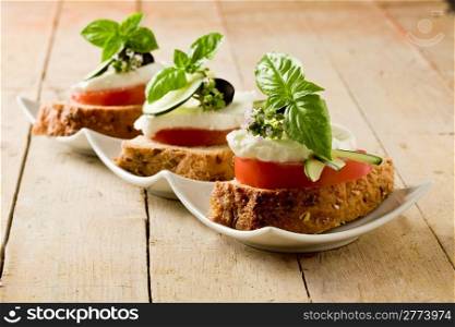 photo of delicious sliced cereal bread with tomato mozzarella