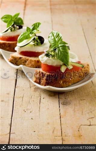 photo of delicious sliced cereal bread with tomato mozzarella