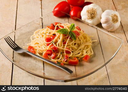 photo of delicious spaghetti with garlic and oil sauce on wooden table