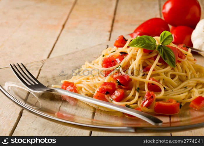 photo of delicious spaghetti with garlic and oil sauce on wooden table