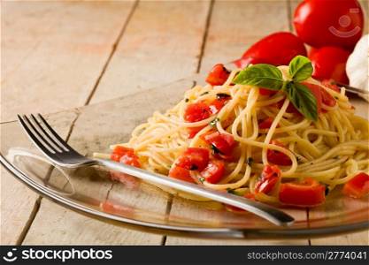 photo of delicious spaghetti with garlic and oil sauce on wooden table