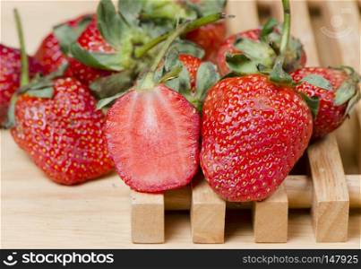 photo of delicious strawberries on wooden table background