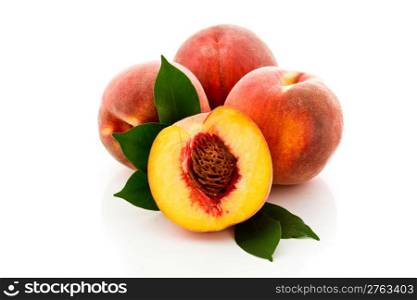 photo of delicious tasty peaches on white background with leaves