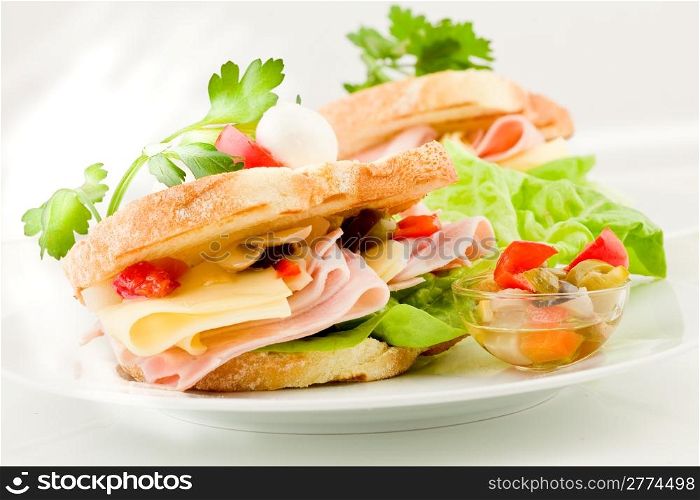 photo of delicious toast stuffed with cheese and ham with lettuce and parsley